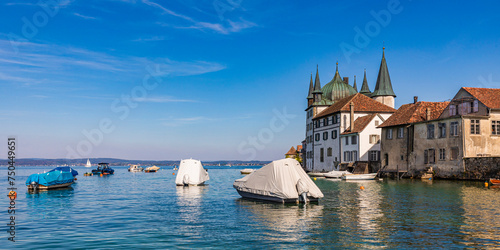 Switzerland, Thurgau, Steckborn, Boats floating at edge of town on lake Bodensee photo