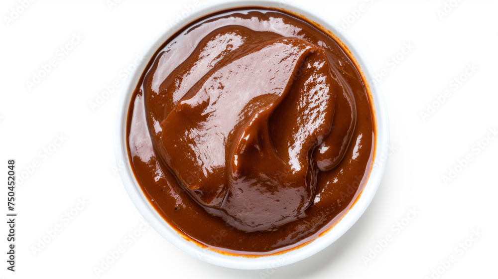 Top-down view of smooth mole sauce in a white bowl with orange trim isolated on a white background. Mexican cuisine concept for culinary arts and menu design Top-down view of smooth mole sauce in a white bowl with orange trim isolated on a white background. Mexican cuisine concept for culinary arts and menu design