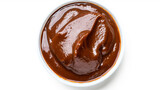Top-down view of smooth mole sauce in a white bowl with orange trim isolated on a white background. Mexican cuisine concept for culinary arts and menu design