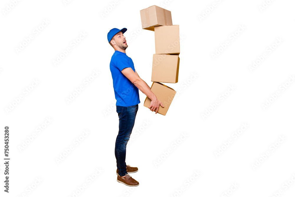 Full body length size, side profile view of handsome scared, shocked bearded deliver in uniform holding four large big flying up in air boxes in arms, isolated over bright vivid yellow background Full body length size, side profile view of handsome scared, shocked bearded deliver in uniform holding four large big flying up in air boxes in arms, isolated over bright vivid yellow background