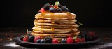 Delicious Homemade Pancakes with Fresh Berries and Sweet Syrup on Rustic Wooden Table