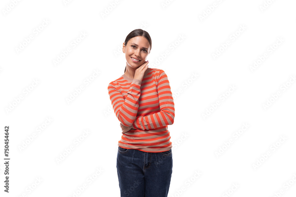 young slender adult woman with a ponytail dressed in an orange striped jacket and jeans is flirting on a white background young slender adult woman with a ponytail dressed in an orange striped jacket and jeans is flirting on a white background