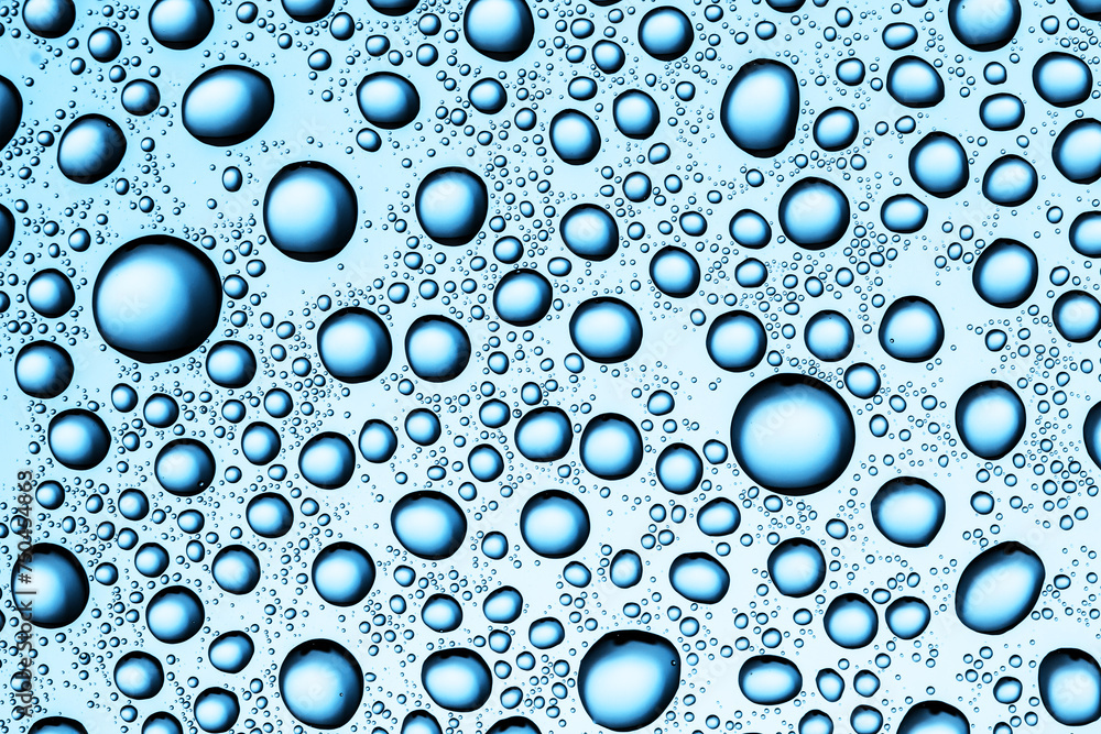 Water drops background. Wet glass surface texture. Winter window condensation problem. Bubble dew pattern. Transparent window blue raindrops. Humidity condensation texture. Blue color water.	
