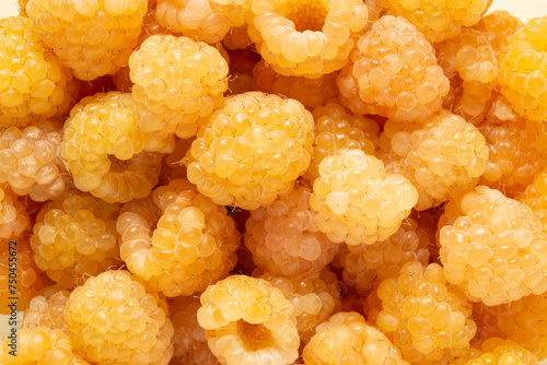 many berries yellow raspberries background