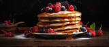 Delicious Pancake Stack Topped with Fresh Berries and Sweet Syrup on Rustic Wooden Table