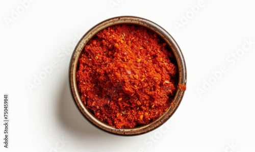Harissa in a small bowl, bright red, top-down view isolated on white background. Spices and condiments concept. Design for spice market advertising, cooking class, recipe ingredient highlight
