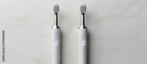 Modern Sonic Toothbrushes Duo on Clean White Surface - Dental Hygiene Concept