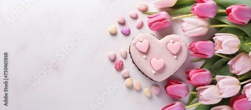 Delicious Heart-Shaped Cake Surrounded by Pink Tulips for Valentine's Day Celebration