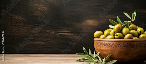 Rustic Wooden Bowl Brimming with Fresh Olives and Olive Branch, Natural Mediterranean Flavors