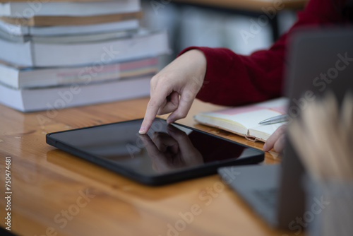 Happy young asian woman doing hands touch at desk in office, Female student with stack of books and laptop.