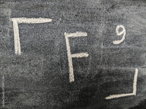 The chemical element fluorine with a serial number from the periodic table. Chalk drawing.