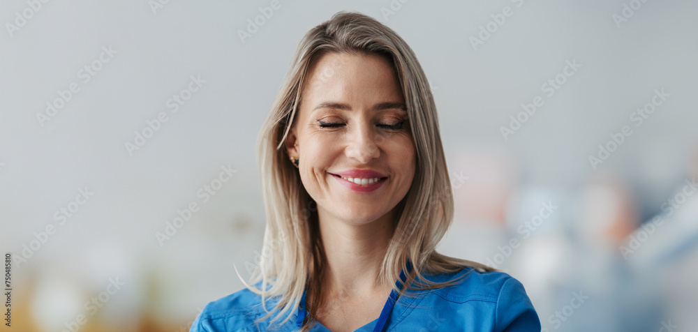 Banner of confident female doctor with closed eyes in hospital. Beautiful nurse wearing blue uniform, holding clipboard standing in modern private clinic. - obrazy, fototapety, plakaty 