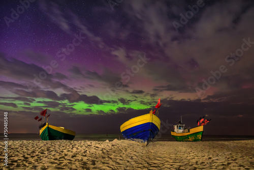 Northern lights over the Baltic Sea on the beach in Jantar with fishing boats  Poland.