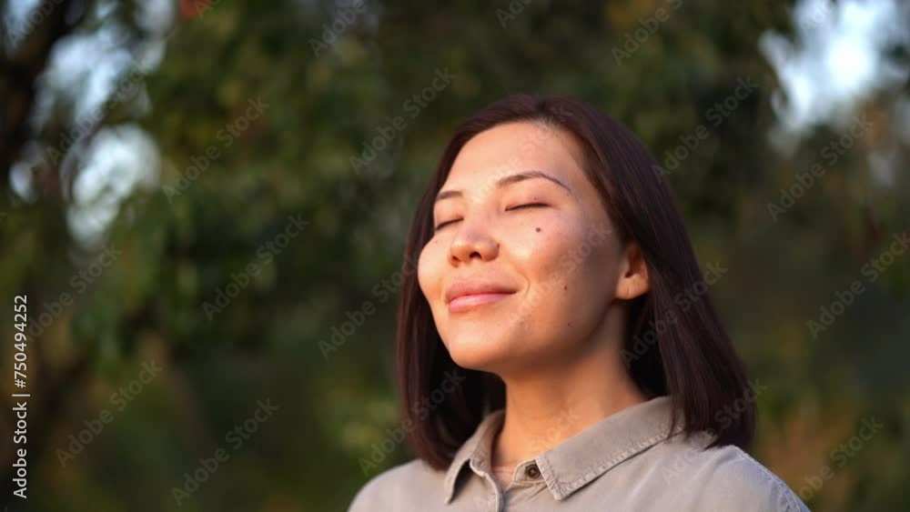 Asian young woman with healthy skin watching the sunset outdoors in summer Asian young woman with healthy skin watching the sunset outdoors in summer
