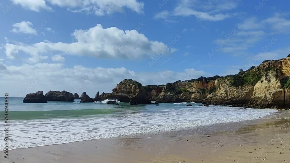 Relaxing beach day, small waves and coastline, clouds in the sky, Portugal, Algarve Relaxing beach day, small waves and coastline, clouds in the sky, Portugal, Algarve