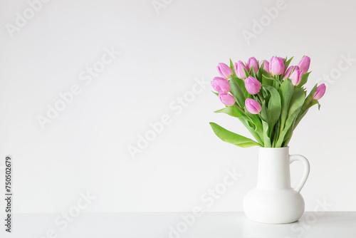 Fototapeta Naklejka Na Ścianę i Meble -  pink tulips in white jug on white background