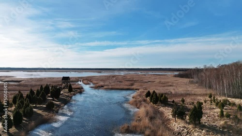 Birdwatching Tower of Riekstusala at Kaniera Lake Lapmezciems, Latvia Reed Trail in Kemeri National Park Fund With Swamps and Many Tiny Lakes. Famous Hiking Destination in Latvia. Slow Motion Shot photo