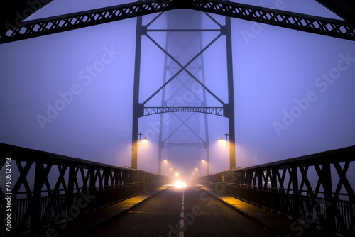 View of the Dom Luis I Iron Bridge at night in thick fog, Porto, Portugal.