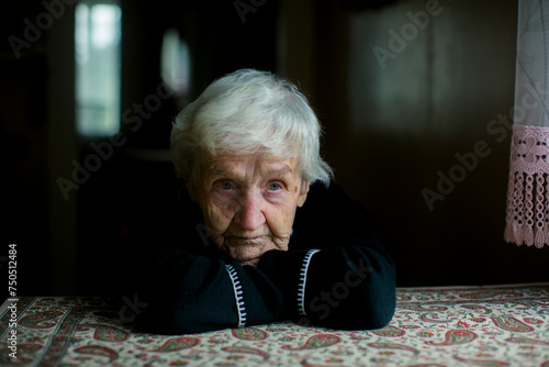 A dramatic portrait of an older gray-haired woman.