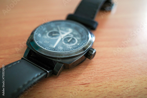 A man watch on the wooden table, shallow focus