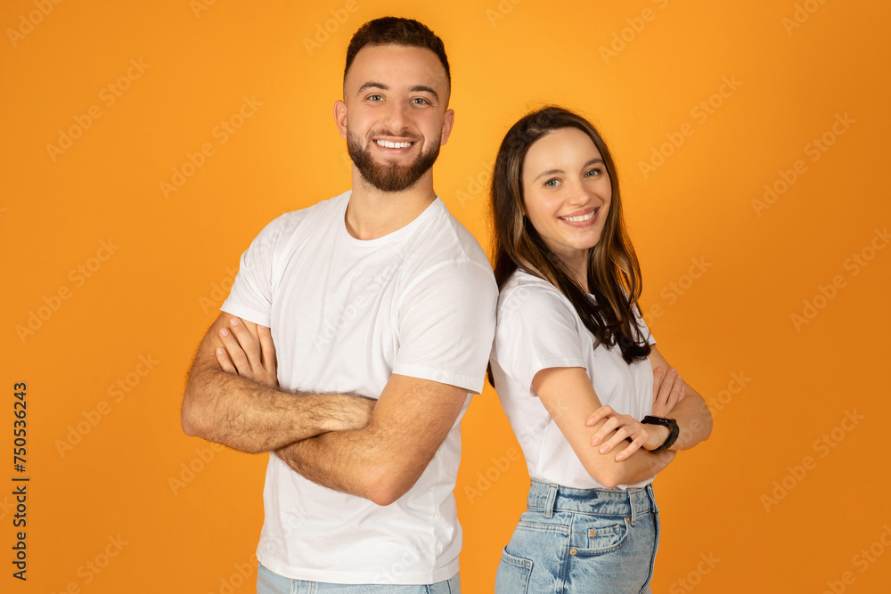 Smiling confident man and woman in white t-shirts with arms crossed, standing side by side Smiling confident man and woman in white t-shirts with arms crossed, standing side by side