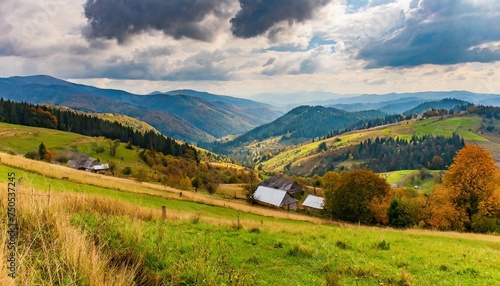 rolling hills of mountainous countryside landscape scenery of carpathian rural area in autumn season on an overcast day village in the valley © Kendrick