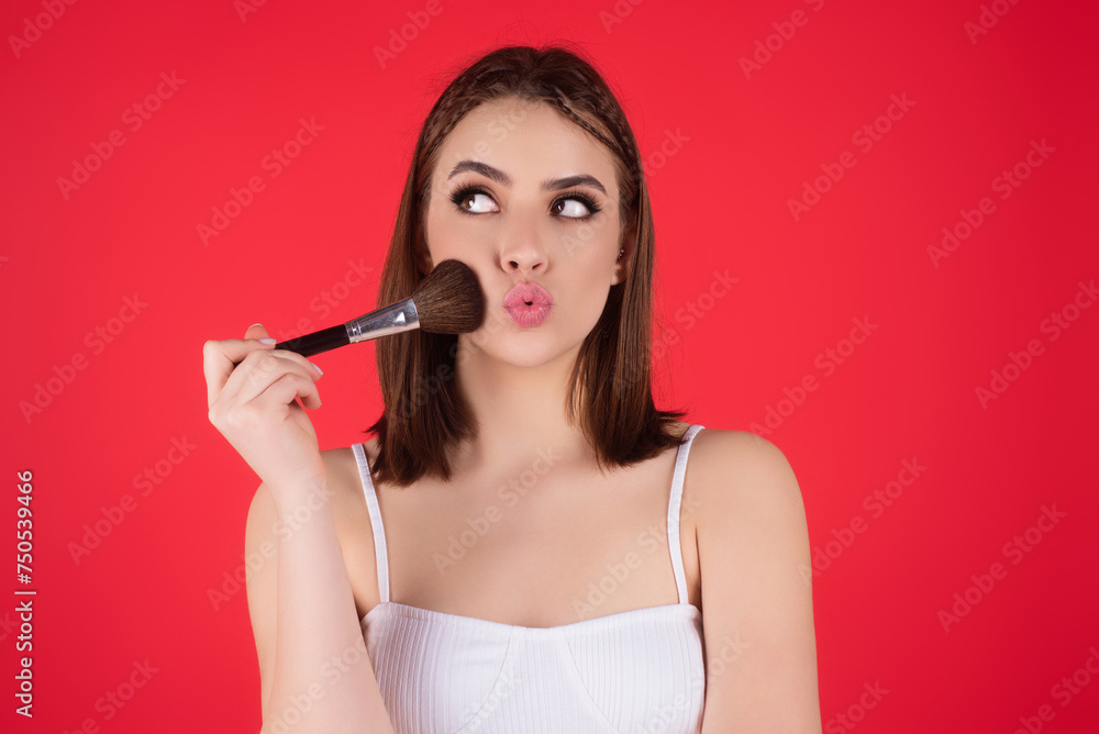 Woman applying foundation powder or blush with makeup brush. Facial treatment, perfect skin, natural make up, facial beauty. Isolated on studio background. Applying makeup. Woman applying foundation powder or blush with makeup brush. Facial treatment, perfect skin, natural make up, facial beauty. Isolated on studio background. Applying makeup.