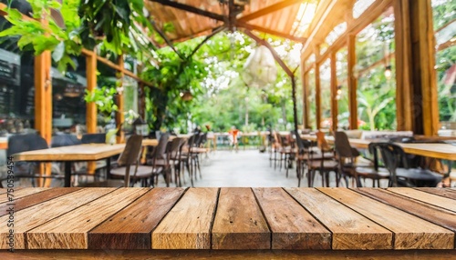 empty wooden table and coffee shop blur background with bokeh image