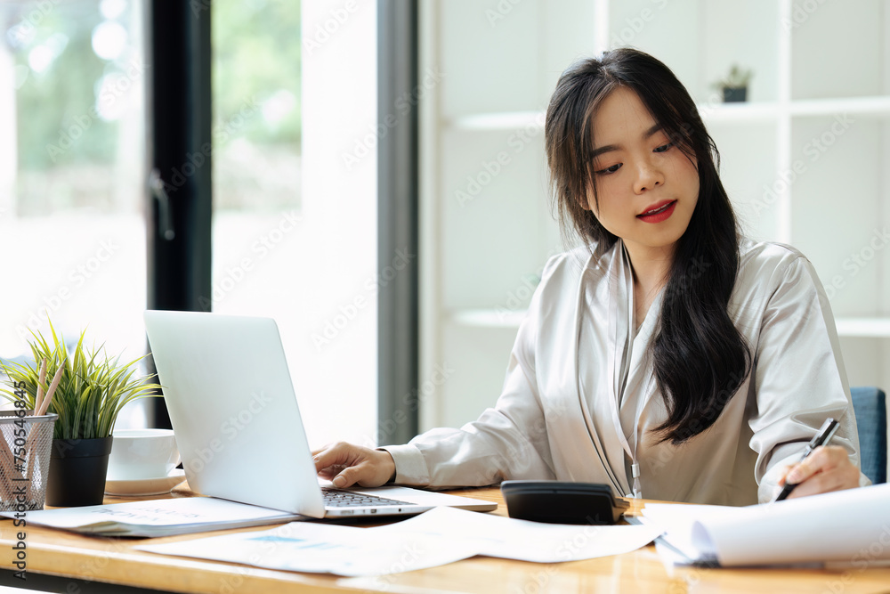 accountant working on desk using calculator for calculate finance report in office accountant working on desk using calculator for calculate finance report in office
