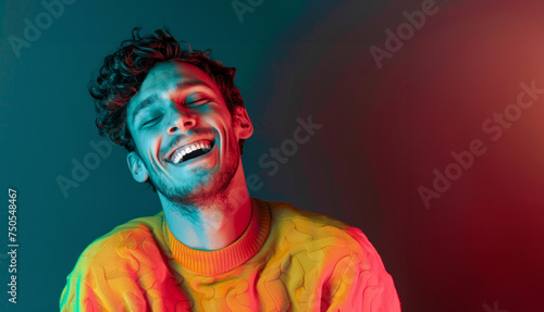 A man with a smile on his face is wearing a yellow shirt. He is looking at the camera and he is happy. Ultra handsome man, smiling and laughing, wearing bright clothes. Bright solid dark background