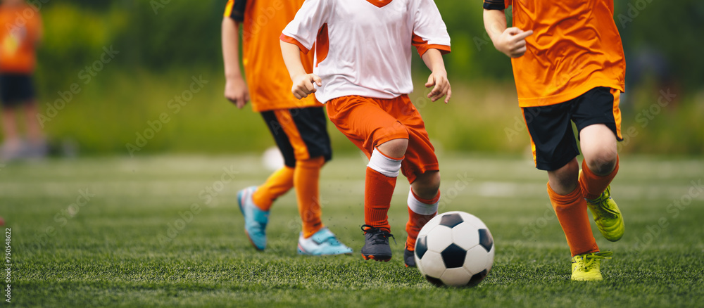 Young Soccer Players Chasing Soccer Ball in a Duel. Kids Play Sports Tournament Match. Two Players Compete For Soccer Ball Young Soccer Players Chasing Soccer Ball in a Duel. Kids Play Sports Tournament Match. Two Players Compete For Soccer Ball