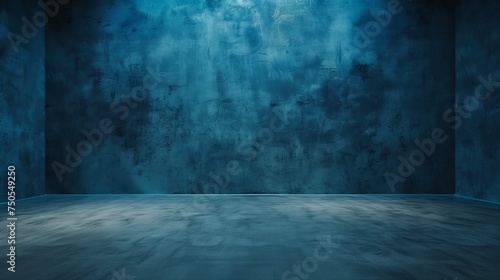 A minimalist dark blue studio backdrop with a smooth gradient  complemented by a neutral grey floor  offering ample copy space for design or text.