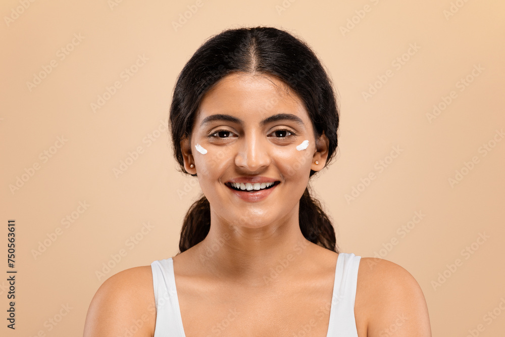 Portrait of cheerful young indian woman with white cream spots on face Portrait of cheerful young indian woman with white cream spots on face