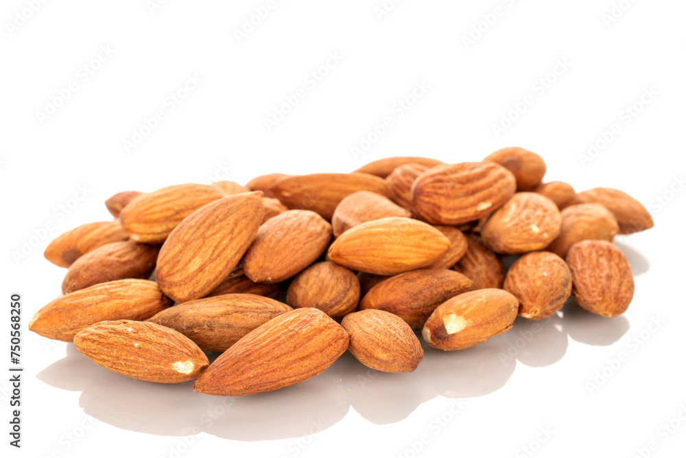 Several roasted almonds, macro, isolated on white background. Several roasted almonds, macro, isolated on white background.