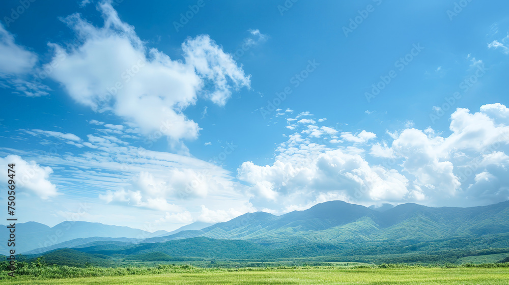 A beautiful blue sky with fluffy clouds and mountains in the background A beautiful blue sky with fluffy clouds and mountains in the background