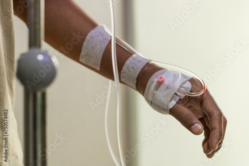 person stands with a cannula in his hand