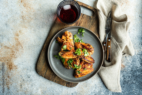 Spicy roasted chicken wings with fresh coriander and cocktail photo