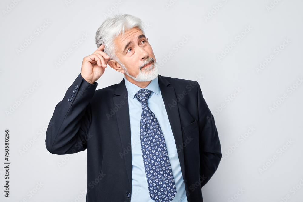 Mature businessman in suit making thinking gesture against a white background. Mature businessman in suit making thinking gesture against a white background.