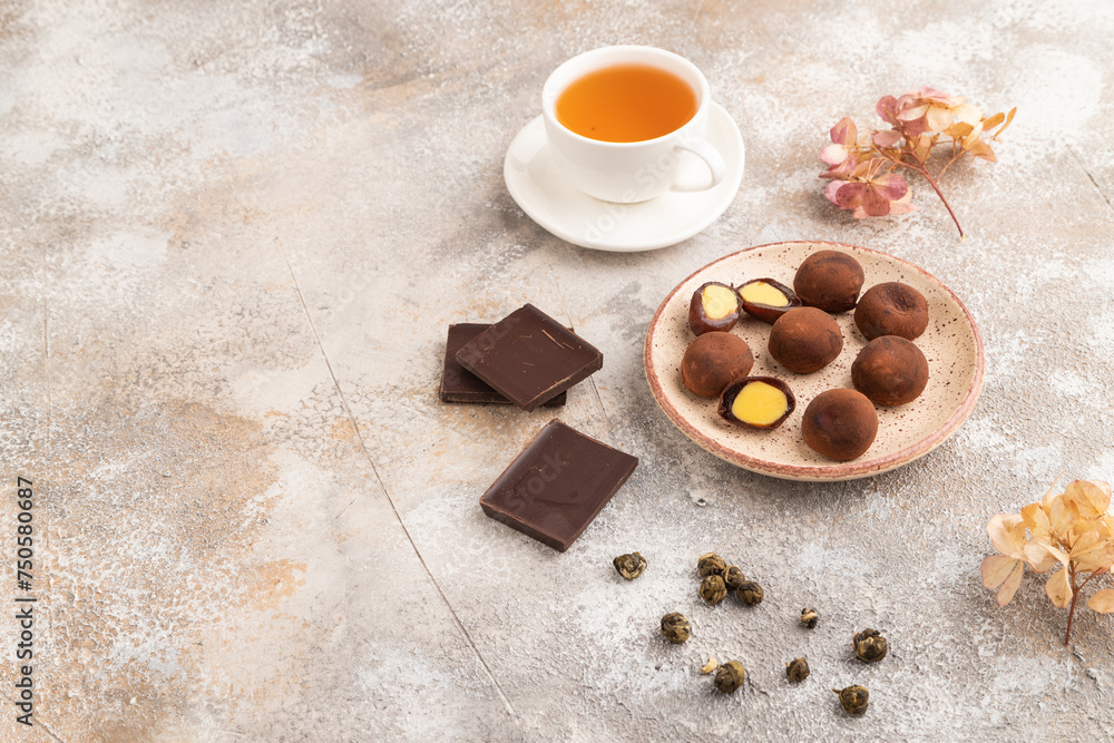 Japanese rice chocolate mochi filled with cream on brown concrete. side view, copy space. Japanese rice chocolate mochi filled with cream on brown concrete. side view, copy space.