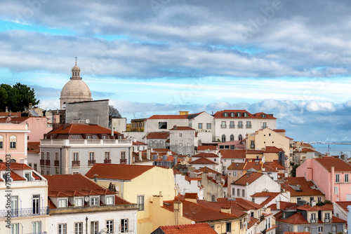 Rooftops of and skyline of a Lisbon, Portugal neighborhood overlooking the Tagus River on a cloudy day