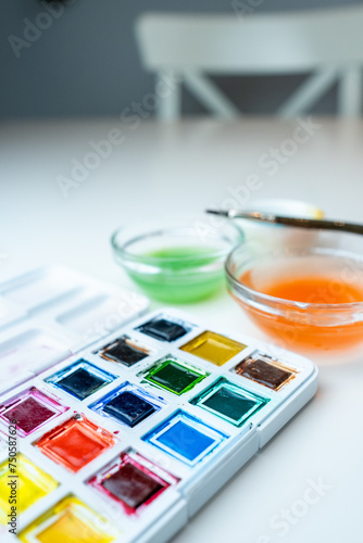 side view of watercolor kit on white background photo