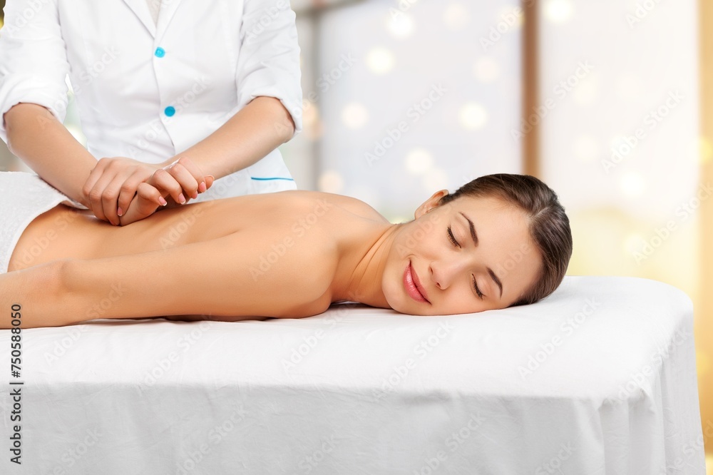 Obraz premium Young woman has back massage in spa salon