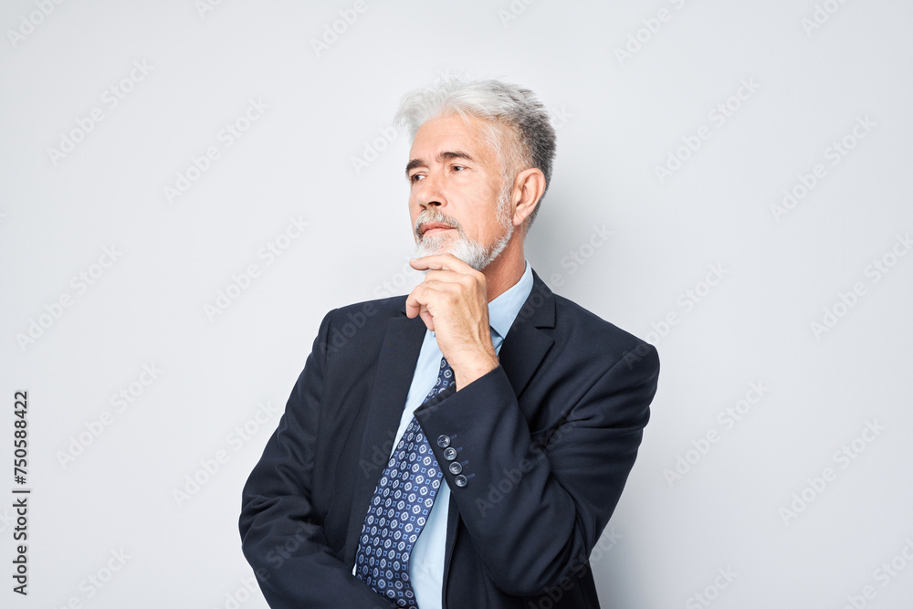 Thoughtful senior businessman hand on chin, contemplating isolated on a light background. Thoughtful senior businessman hand on chin, contemplating isolated on a light background.