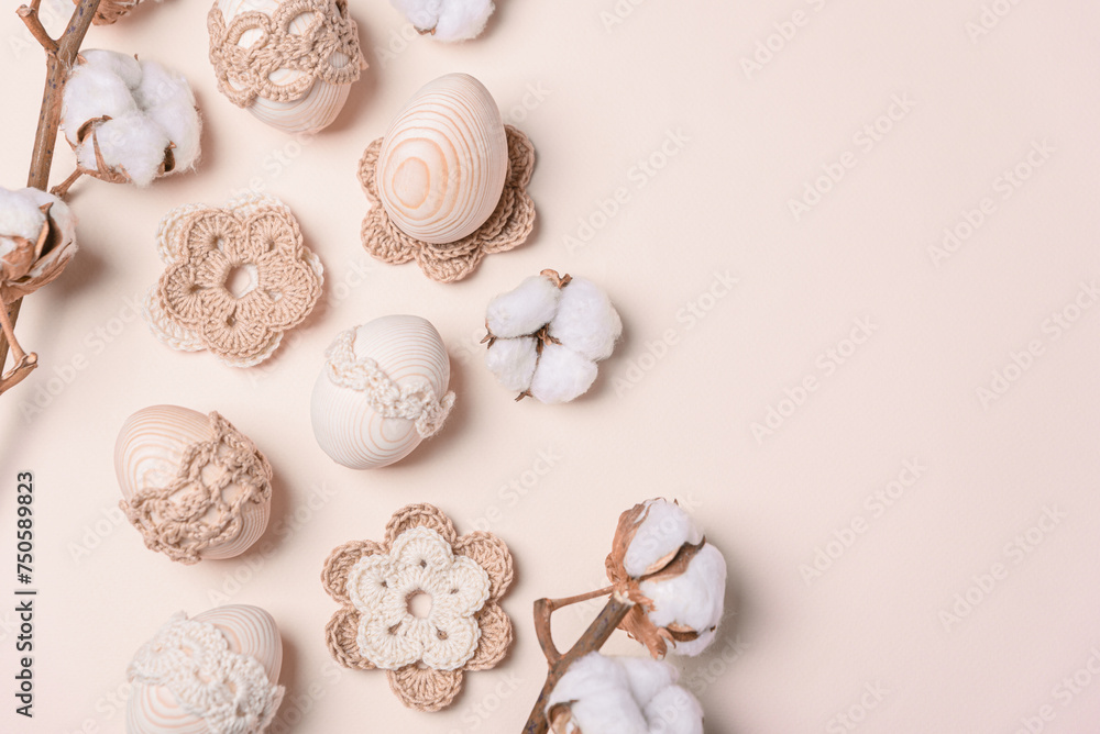 Craft eggs, knitted and cotton flowers on soft beige background. Top view. Copy space Craft eggs, knitted and cotton flowers on soft beige background. Top view. Copy space