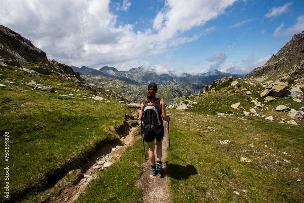 Young hiker girl summit to Ratera Peak in Aiguestortes and Sant Maurici National Park, Spain