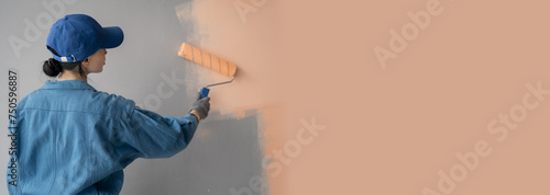 Woman painting house room with paint roller. House painting and renovation business concept.