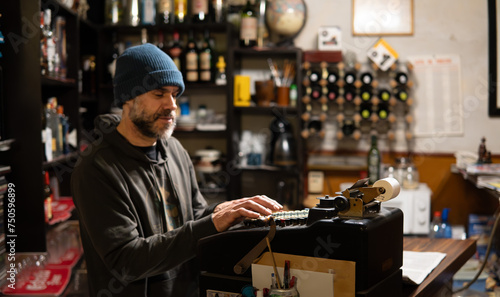 Waiter cashing up at antique cash register in an old traditional restaurant in Toledo Spain. © PHOTOSORIA