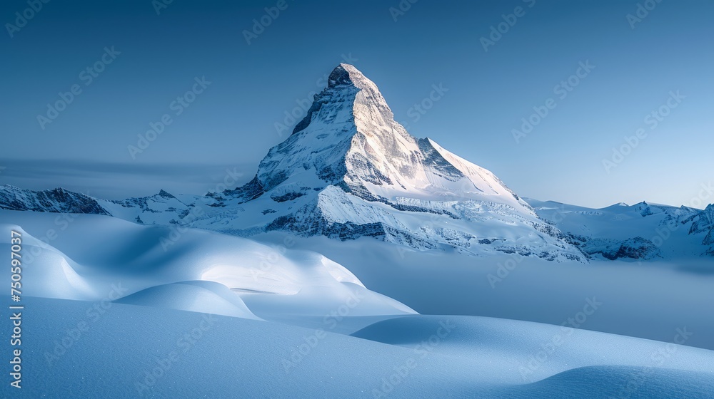 Majestic Snow-Capped Mountain Peak Towering Above Pristine Winter Landscape Under Serene Blue Sky