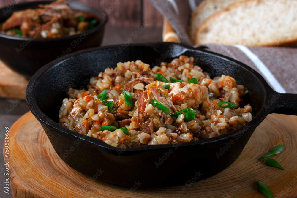 Meat with buckwheat served in the cast iron pan. Nutritious meal for lunch or dinner Meat with buckwheat served in the cast iron pan. Nutritious meal for lunch or dinner