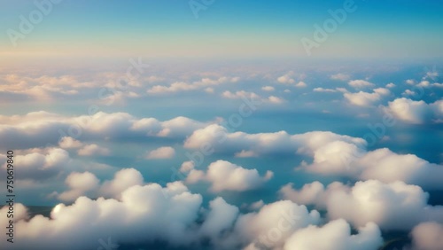 Aerial majesty: boundless blue sky above the cotton-like embrace of clouds. Meteorology concept. Cinematic footage. Time lapse. Winter sky background.  4K UHD.
